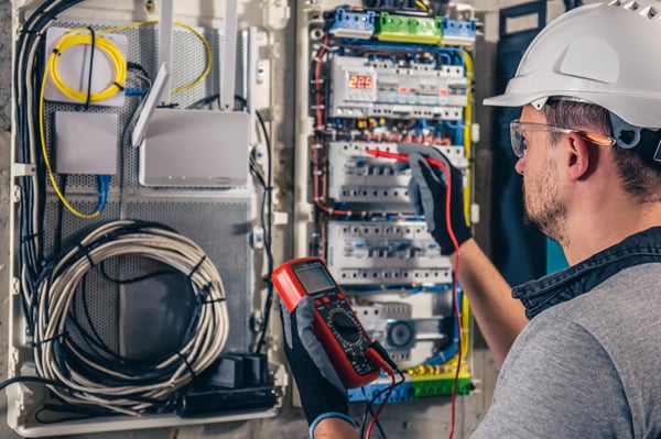 man-electrical-technician-working-switchboard-with-fuses-1